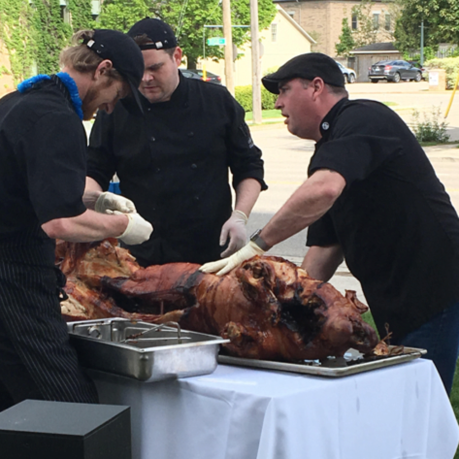Chefs serving pig roast